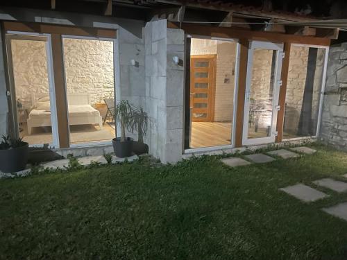 a patio with sliding glass doors on a house at Tatsopus in Kamianets-Podilskyi
