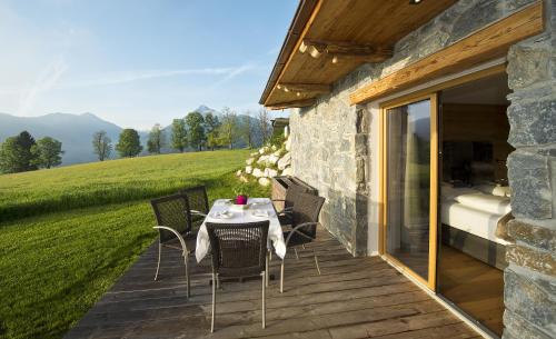 a table and chairs on a deck with a bed at Chalet Winterbauer in Flachau