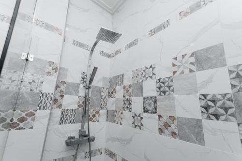 a shower with a shower head in a bathroom at Ying Yang House Sawankhalok in Sawankhalok