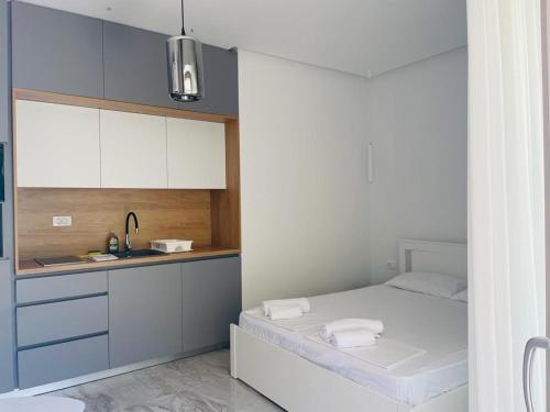 uma pequena cozinha com uma cama e um lavatório em AURA TOWER Apartments by Gaby em Rafailovici