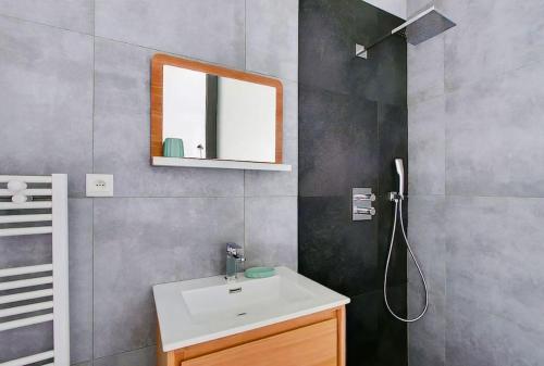 a bathroom with a sink and a mirror at Unforgettable Stay in the Heart of Paris in Paris