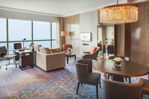 a living room with a couch and a table at InterContinental Hanoi Landmark72 by IHG in Hanoi