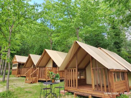 a row of wooden lodges in the woods at Saecula Natural Village Experience in Force
