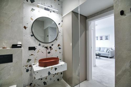 a bathroom with a mirror on the wall at Black Goat 81 Apartaments in Zator