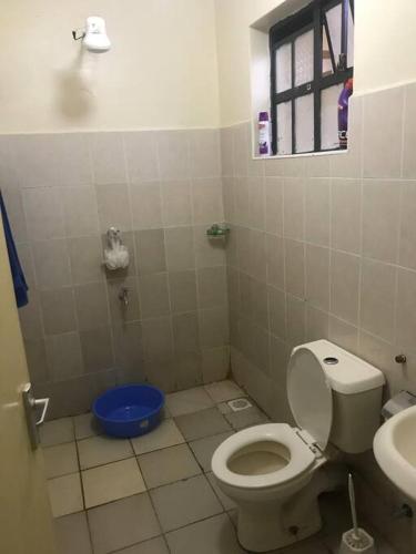 a bathroom with a toilet and a sink at Sweet Awesome One bedroom stay. in Eldoret