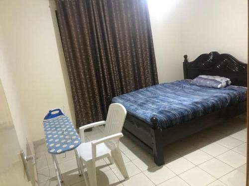a small bedroom with a bed and a chair at Sweet Awesome One bedroom stay. in Eldoret