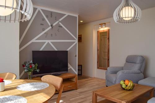 a living room with a clock on the wall at Kuuse 4 Apartment in Haapsalu