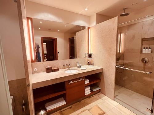 a bathroom with a sink and a shower at Schloss Elmau Luxury Spa Retreat & Cultural Hideaway in Elmau