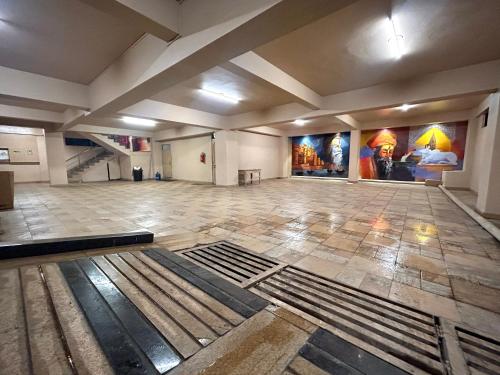 a large empty room with paintings on the walls at Sugar Stars Inn in Varanasi