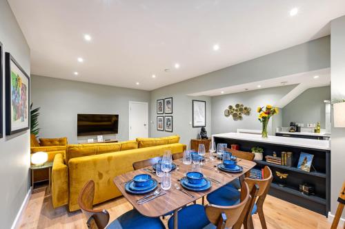 a living room with a table and a yellow couch at Host & Stay - Catharine Quarters in Liverpool