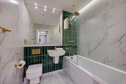a bathroom with a sink and a toilet and a tub at Host & Stay - Catharine Quarters in Liverpool