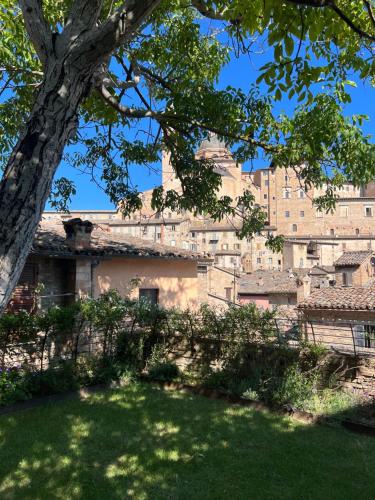 a view of a building with a tree in the foreground at Urbino Apartment - Torricini View in Urbino