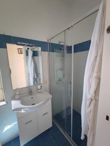 a bathroom with a sink and a shower at La casa di Nonna Rosa in Procida