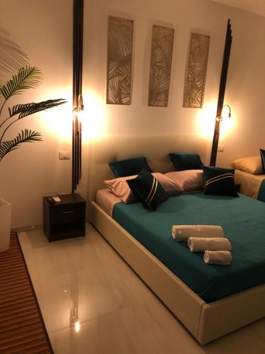 a bedroom with a bed with two towels on it at Monolocale Casa Palma in Nardò