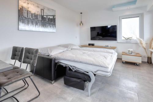 TV a/nebo společenská místnost v ubytování Terrassenhaus Duhnen Wohnung 77