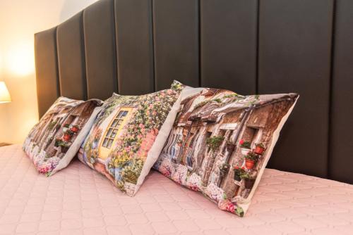 two pillows sitting on top of a bed at Guest House Pasaulio Krastas in Palanga