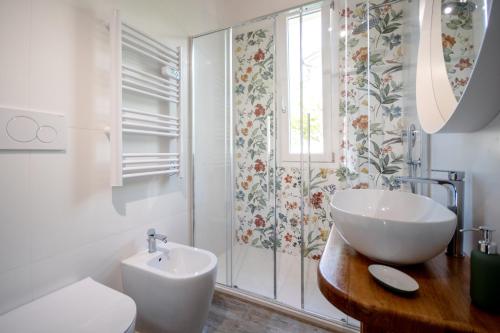 a bathroom with a sink and a toilet and a window at La Casetta in Riccò del Golfo di Spezia