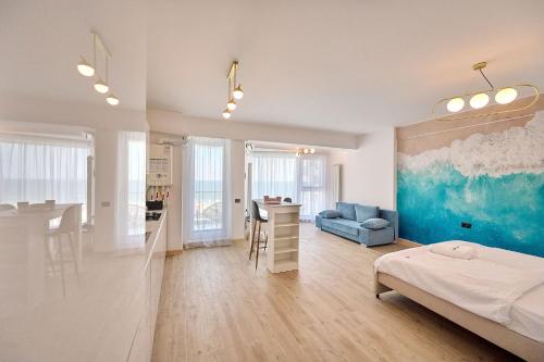 a bedroom with a bed and a kitchen and a living room at Sea-esta Studio in Infinity Beach Resort in Mamaia