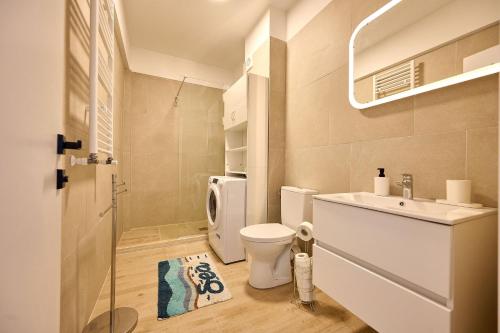 a bathroom with a white toilet and a sink at Sea-esta Studio in Infinity Beach Resort in Mamaia