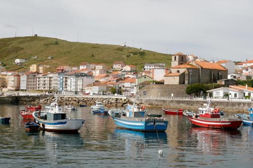 a group of boats are docked in a harbor at camiño dos faros in Ponteceso