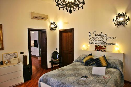 a bedroom with a bed with a laptop on it at Casa Vacanze Via Roma 148 in Siracusa