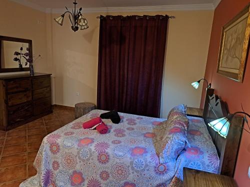 a bedroom with a table with a purple table cloth at Casa El Albero (Torcal-Caminito del Rey) in La Joya