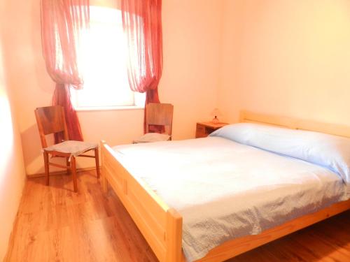 a bedroom with a bed and a window at Apartment Deni in Lumbarda