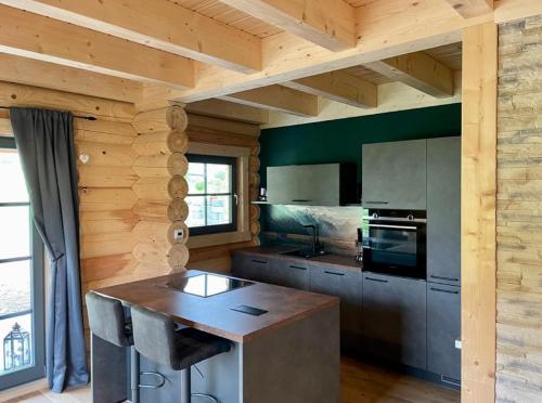 a kitchen with wooden walls and a wooden counter top at Das Landchalet in Steinwiesen