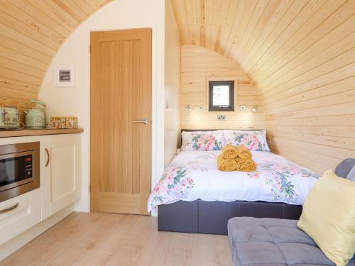 a bedroom with a bed with two donuts on it at Eirlys in Dolgellau