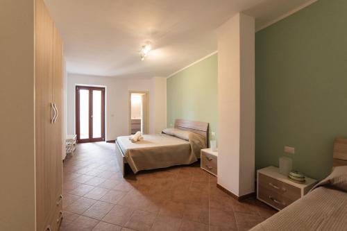 una camera con un letto in una stanza con pareti verdi di La Primula di Palinuro a Celle di Bulgheria