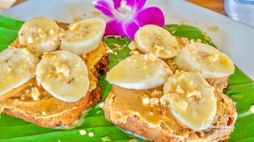 a plate of food with toast with bananas on it at Kalulushi Bungalows in Haad Pleayleam