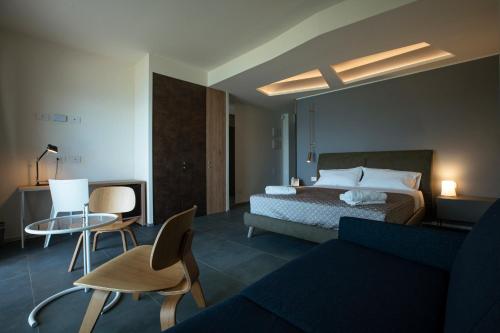 a hotel room with a bed and a couch at Hotel Belvedere Resort in Castellammare del Golfo