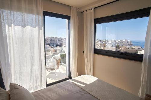 a bedroom with a bed and a large window at White Coast in Polignano a Mare