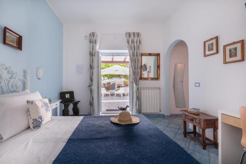 a bedroom with a bed with a hat on it at BnB Le Isole in Ischia