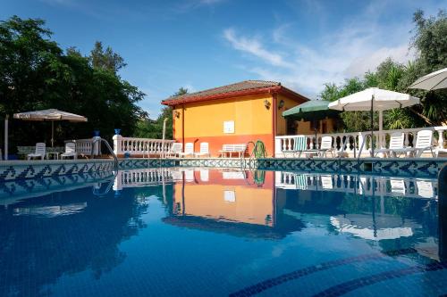 a house with a swimming pool in front of it at Hotel Zeus in Mérida