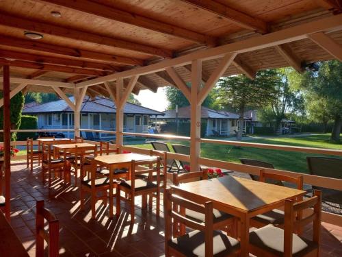 a row of tables and chairs on a patio at SZÉP BALATON in Balatongyörök