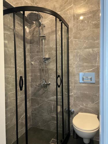 a shower stall with a toilet in a bathroom at Moni Homes in Fethiye