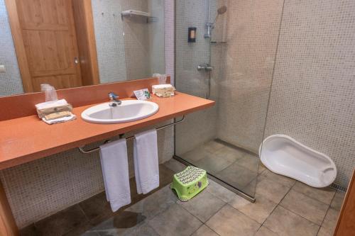 a bathroom with a sink and a shower and a toilet at Vilar Rural De Sant Hilari Sacalm by Serhs Hotels in Sant Hilari Sacalm