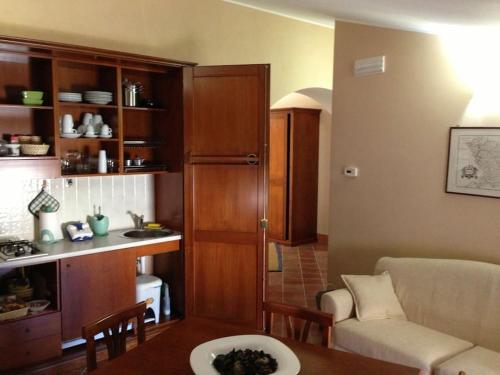 a kitchen and a living room with a couch and a table at Antica dimora Palazzo Rossi in Marsico Vetere