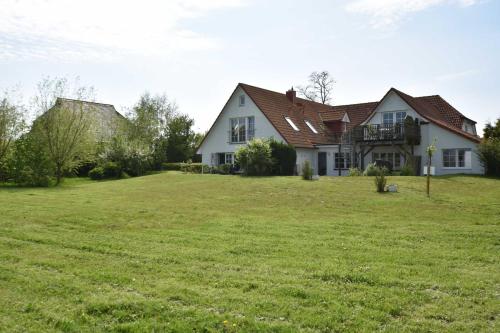 a house with a large yard with green grass at Ferienwohnungen "Zum Breitling" OVS 691 in Fährdorf