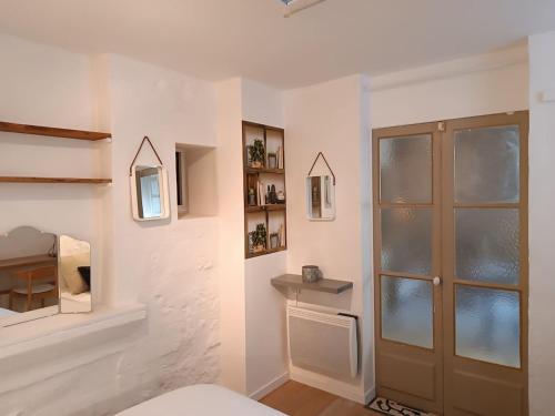 Cette chambre dispose d'une porte et d'un mur avec des étagères. dans l'établissement Cosy appartement intra-muros, à Avignon