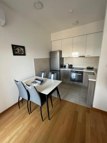 a kitchen with a table and chairs in a room at Apartmani Kastel in Banja Luka