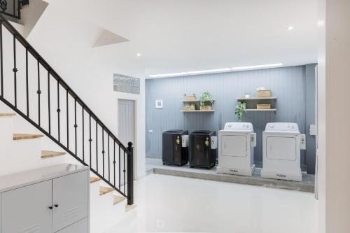 a room with three trash cans and a staircase at Casa Luna in Bangkok