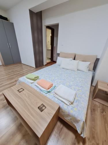 a bedroom with a bed with two towels on it at Bojana Apartment in Negotino