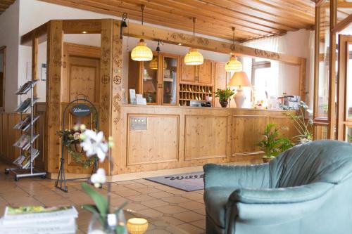 a living room with wooden cabinets and a couch at Landgasthof-Wemmer in Großrückerswalde