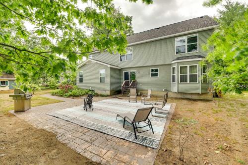 a house with a patio and chairs in the yard at Woodsy Ballston Spa Home 4 Mi to State Park! in Ballston Spa