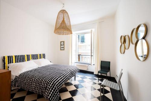 a bedroom with a bed and a checkered floor at Genoese design city apartment in Genova