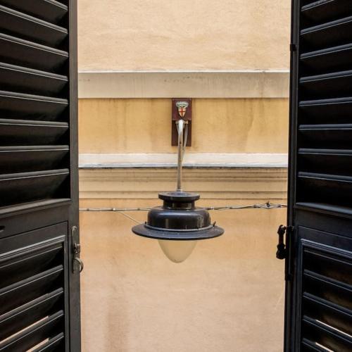 a light hanging from the side of a building at Genoese design city apartment in Genoa