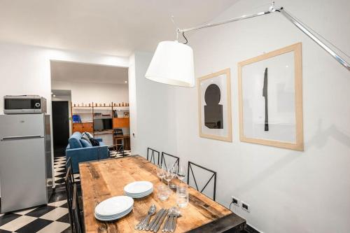 a kitchen and dining room with a wooden table at Genoese design city apartment in Genova