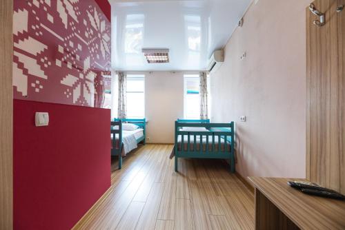 a room with two beds and a red wall at Guest house "Golden Gate 911 " in Kyiv
